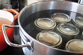 Pickling jars in a pot full of water