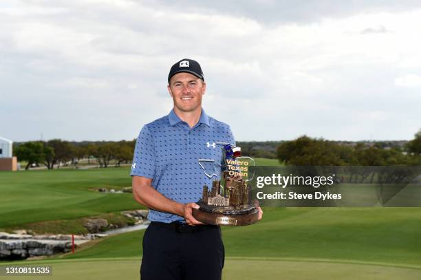 Jordan Spieth poses with the trophy after putting in to win during the final round of Valero Texas Open at TPC San Antonio Oaks Course on April 04,...