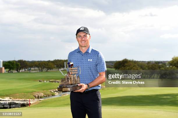 Jordan Spieth poses with the trophy after putting in to win during the final round of Valero Texas Open at TPC San Antonio Oaks Course on April 04,...