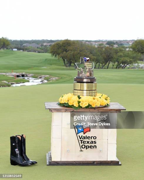 The trophy and cowboy boots are seen on the 18th green during the final round of Valero Texas Open at TPC San Antonio Oaks Course on April 04, 2021...