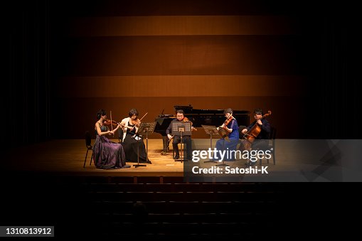 Five musicians playing violin, viola, and cello at classical music concert Five musicians playing violin, viola, and cello at classical music concert