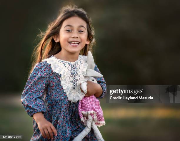 laughing running joyful little girl - american girl doll stock pictures, royalty-free photos & images