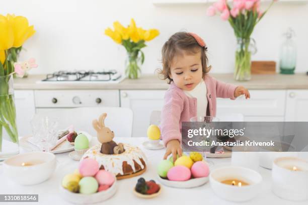 beautiful cute little baby girl celebrating easter at home. - easter breakfast stock pictures, royalty-free photos & images