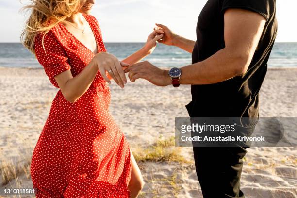 happy couple having fun on the beach. - bonding stock pictures, royalty-free photos & images