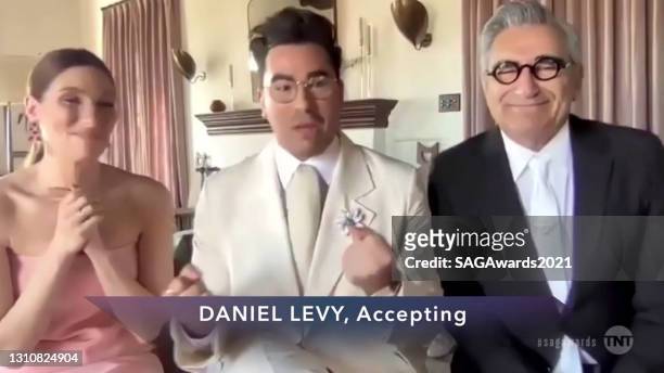 In this screengrab released on April 4 Sarah Levy, Dan Levy, and Eugene Levy, winners of Outstanding Performance by an Ensemble in a Comedy Series...