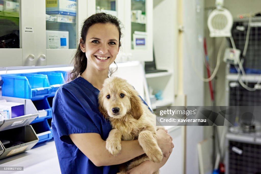 Indoor Portrait of Veterinary Technician and Young Dog
