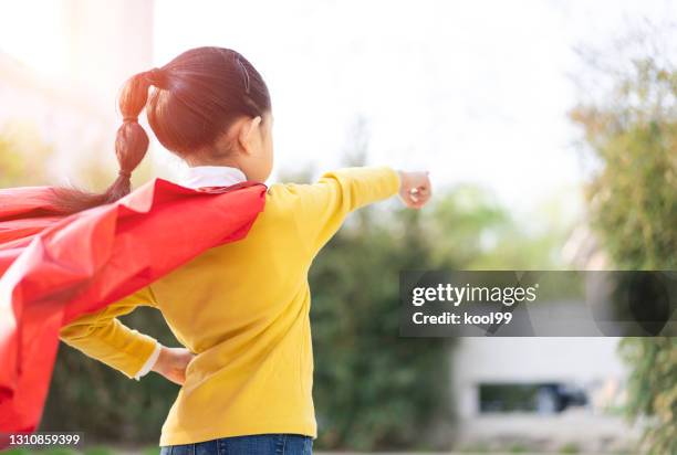 superwoman pointing target - superhero pose stock pictures, royalty-free photos & images