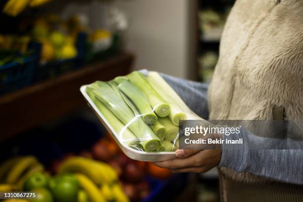 woman checking milk label in vegetable section of supermarket - expiry date stock pictures, royalty-free photos & images