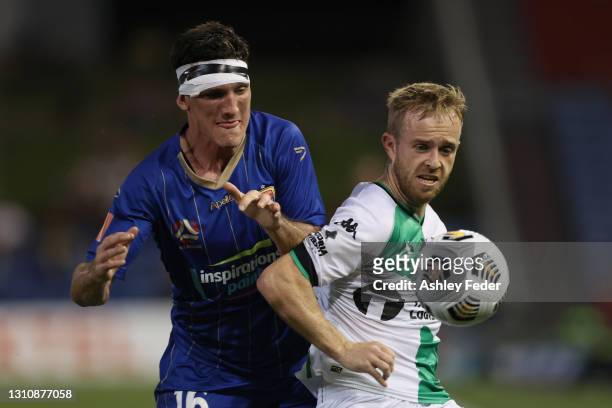 Matthew Millar of the Jets contests the ball against Connor Pain of Western United during the A-League match between the Newcastle Jets and Western...