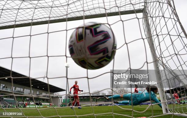 Laura Benkarth of FC Bayern Munchen dives but fails to save the ball for VfL Wolfsburg's first goal scored by Alexandra Popp of Vfl Wolfsburg at...