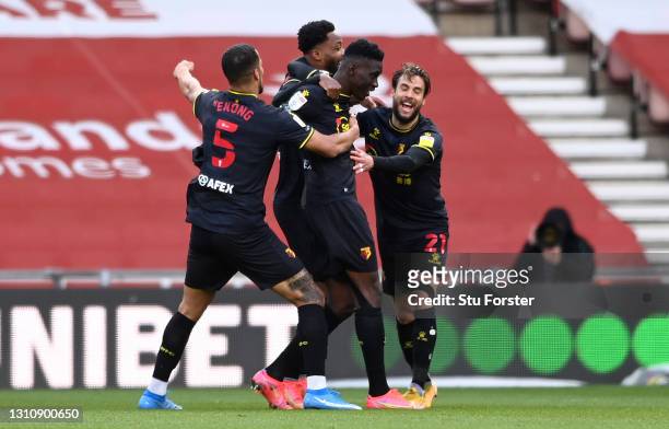 Ismaila Sarr of Watford celebrates with team mates William Troost-Ekong, Kiko Femenia and Nathaniel Chalobah after scoring their side's first goal...