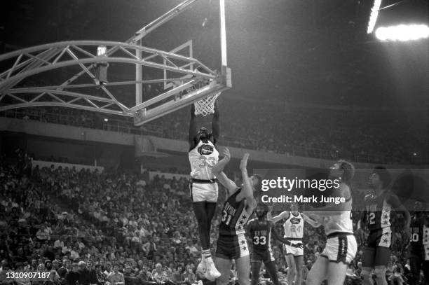 Denver Nuggets forward David Thompson dunks the ball during an ABA basketball game against the New York Nets at McNichols Arena on November 8, 1975...