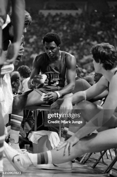 New York Nets guard John Williamson takes a drink on the bench during a timeout of an ABA basketball game against the Denver Nuggets at McNichols...