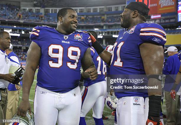 Marcell Dareus of the Buffalo Bills talks to Spencer Johnson after defeating the Washington Redskins at Rogers Centre on October 30, 2011 in Toronto,...