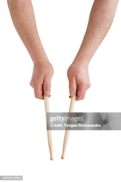 drumsticks in hands isolated on white background - drumstok stockfoto's en -beelden