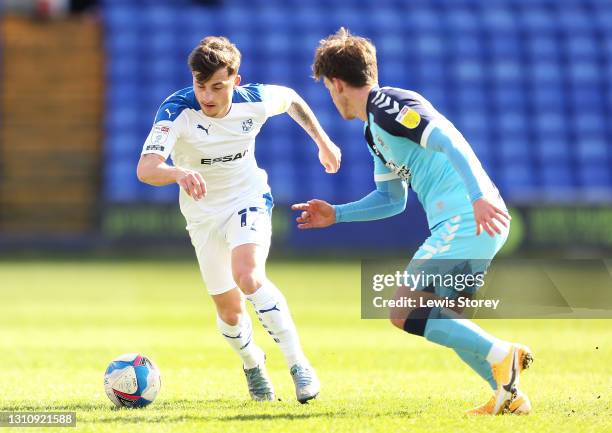 Otis Khan of Tranmere Rovers runs with the ball whilst under pressure from Luke Hannant of Cambridge United during the Sky Bet League Two match...