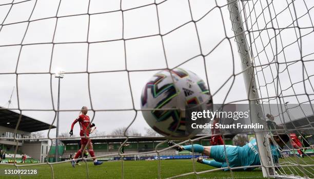 Laura Benkarth of FC Bayern Munchen dives but fails to save the ball for VfL Wolfsburg's first goal scored by Alexandra Popp of Vfl Wolfsburg at...