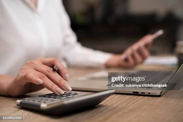 savings, finances and economy concept.close up hand of businesswoman accountant or banker making calculations. - tax return stock pictures, royalty-free photos & images