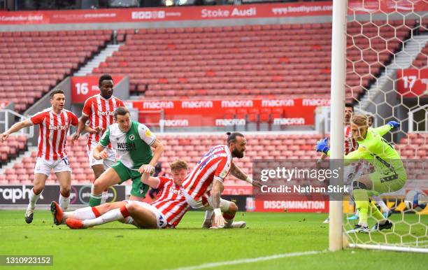 Murray Wallace of Millwall FC scores their team's first goal fast Steven Fletcher and Adam Davies of Stoke City during the Sky Bet Championship match...