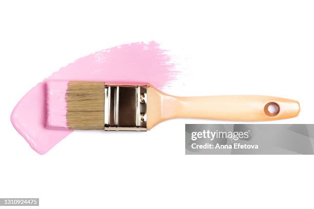 paintbrush and smooth smear of pink pigment isolated on white background. concept of home repair. flat lay style and close-up - brush stroke on white stock-fotos und bilder