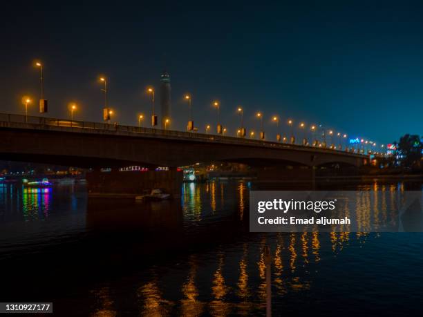 qasr el nil bridge span the nile river in central cairo, egypt - qasr el nil bridge stock pictures, royalty-free photos & images