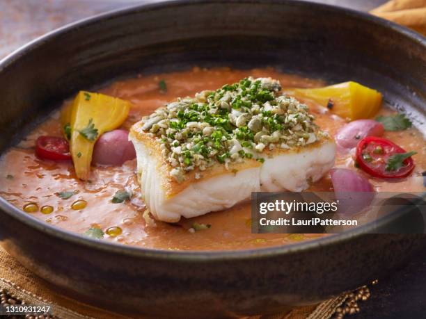 pan seared halibut with pumpkin seed gremolata with a coconut curry sauce - halibut stock pictures, royalty-free photos & images