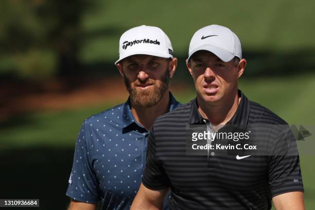 Dustin Johnson of the United States and Rory McIlroy of Northern Ireland walk on the seventh hole during a practice round prior to the Masters at...