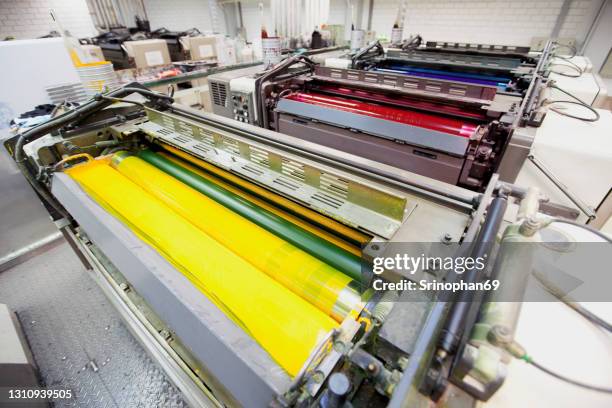 offset printing press cmyk ink - stampare foto e immagini stock