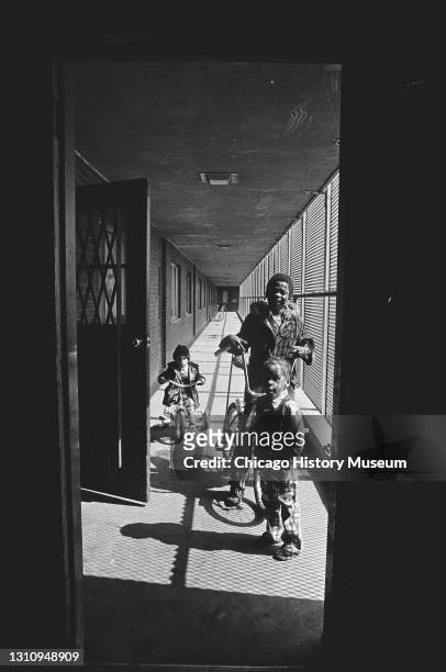 Children playing in the hallway at Cabrini-Green housing projects, Chicago, Illinois, June 25, 1976.
