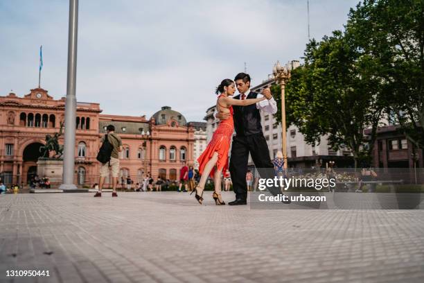 latin couple dancing tango on town square - casa rosada stock pictures, royalty-free photos & images