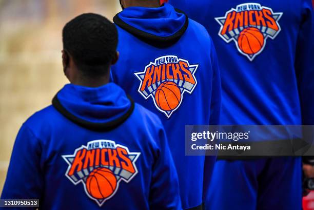 The New York Knicks logo is seen as players from the bench watch the first quarter of the NBA game against the Detroit Pistons at Little Caesars...