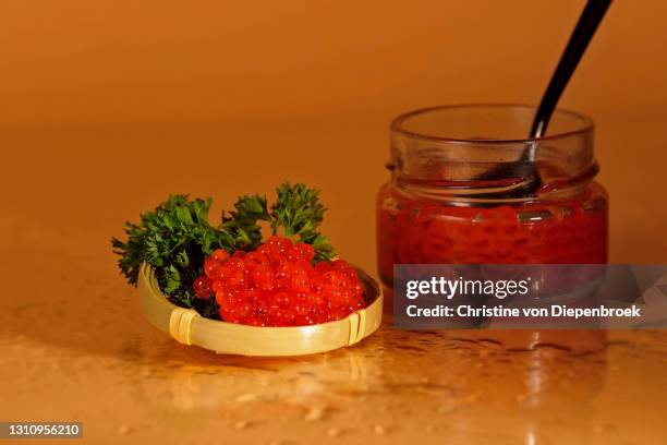 red caviar on plain background - red caviar stock pictures, royalty-free photos & images