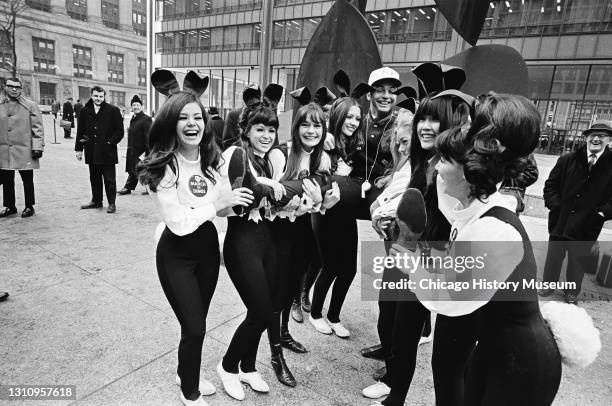 Chicago Bears running back Brian Piccolo and twelve Playboy Bunnies appear at the Civic Center Plaza to promote the beginning of the March of Dimes,...