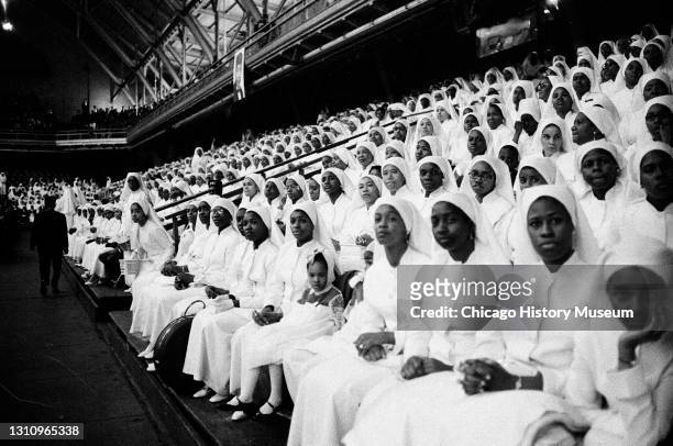 Leader of the Nation of Islam, Elijah Muhammad, speaks to a crowd at the Black Muslims annual meeting held in the Coliseum at 15th Street and Wabash...