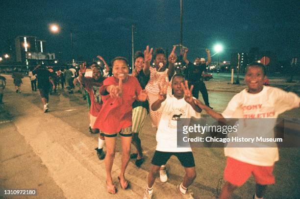 Chicago Bulls fans parade the streets in response to the sixth NBA championship game against the Phoenix Suns, Chicago, Illinois, June 20, 1993.
