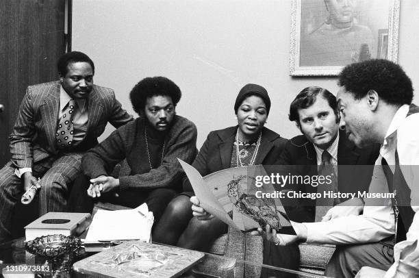 Widow of Malcolm X, Betty Shabazz, sits with Dr Charles Hurst, Reverend Jesse Jackson, and other officials, February 22, 1972.