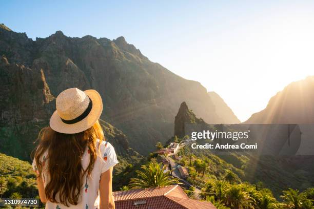 rear view of tourist admiring the village of masca, tenerife, canary islands, spain - canary islands 個照片及圖片檔