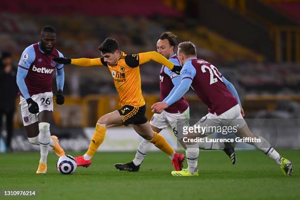 Pedro Neto of Wolverhampton Wanderers battles for possession with Arthur Masuaku , Mark Noble and Jarrod Bowen of West Ham United during the Premier...