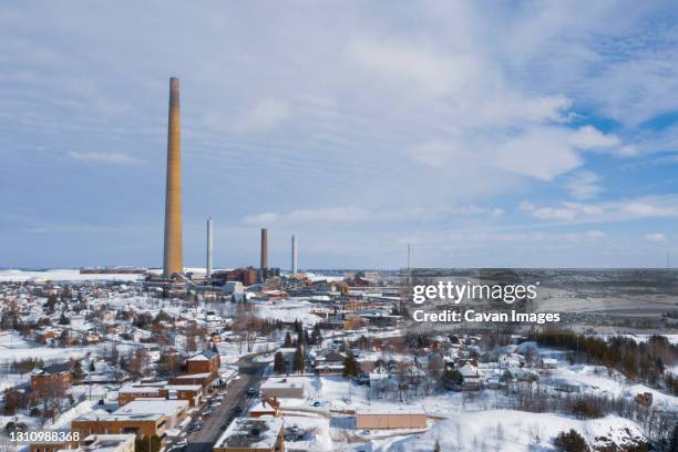 smoke stack rises 1000 ft. over wintery town - sudbury stock pictures, royalty-free photos & images