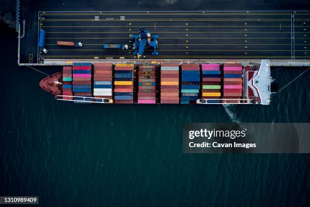 cargo ship with containers in port - barge fotografías e imágenes de stock