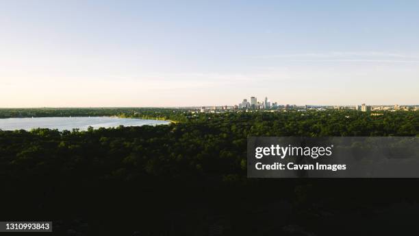 wide angle view of the minneapolis skyline and lake calhoun - minneapolis drone stock pictures, royalty-free photos & images