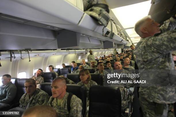 Army soldiers sit on a plane as they begin their journey home out of Iraq from the al-Asad Air Base west the capital Baghdad, on November 1, 2011....