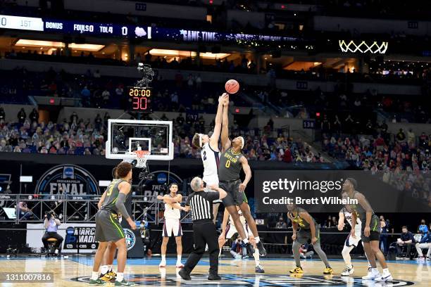 Drew Timme of the Gonzaga Bulldogs and Flo Thamba of the Baylor Bears compete for the opening tip-off to start the National Championship game of the...