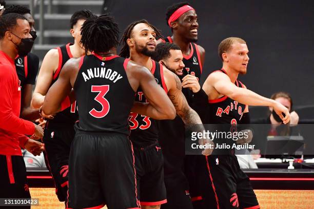 Gary Trent Jr. #33 of the Toronto Raptors celebrates with teammates after scoring a 3-point buzzer beater to defeat the Washington Wizards 103-101 at...