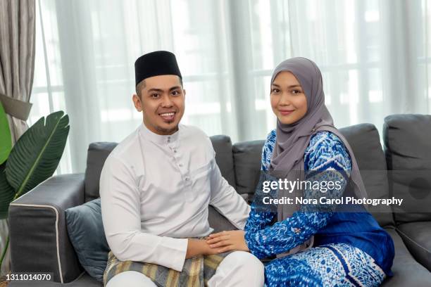 malay couple with malay attire - hijab, baju kurung, songkok, baju melayu. - baju melayu stock pictures, royalty-free photos & images