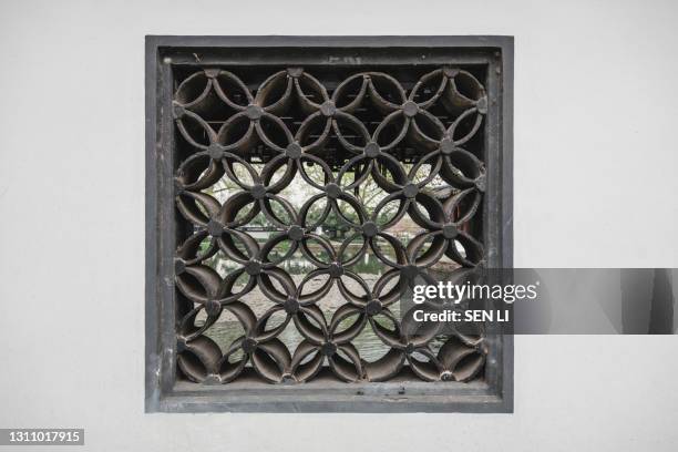 traditional stone wall and window background with plants of a classic chinese garden in hangzhou, china - heritage classic fotografías e imágenes de stock