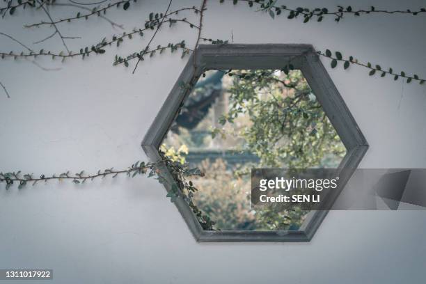 traditional stone wall and window background with plants of a classic chinese garden in hangzhou, china - heritage classic fotografías e imágenes de stock