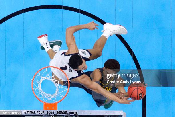 MaCio Teague of the Baylor Bears goes up for a basket against Jalen Suggs of the Gonzaga Bulldogs in the National Championship game of the 2021 NCAA...