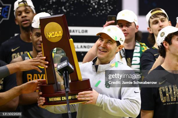 Head coach Scott Drew of the Baylor Bears holds the trophy as the team celebrates with the trophy after their win against the Gonzaga Bulldogs in the...