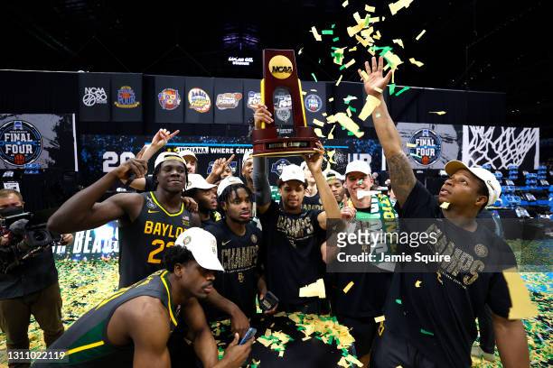 MaCio Teague of the Baylor Bears holds up the trophy after defeating the Gonzaga Bulldogs 86-70 in the National Championship game of the 2021 NCAA...